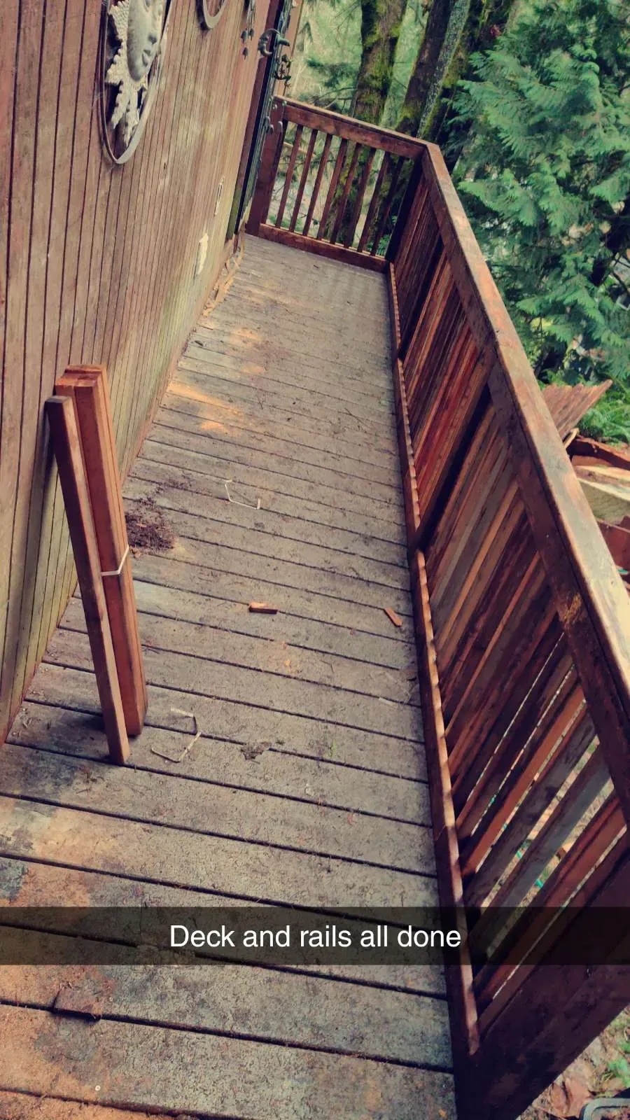 Completed residential deck with railing, finished decking boards, and guardrails