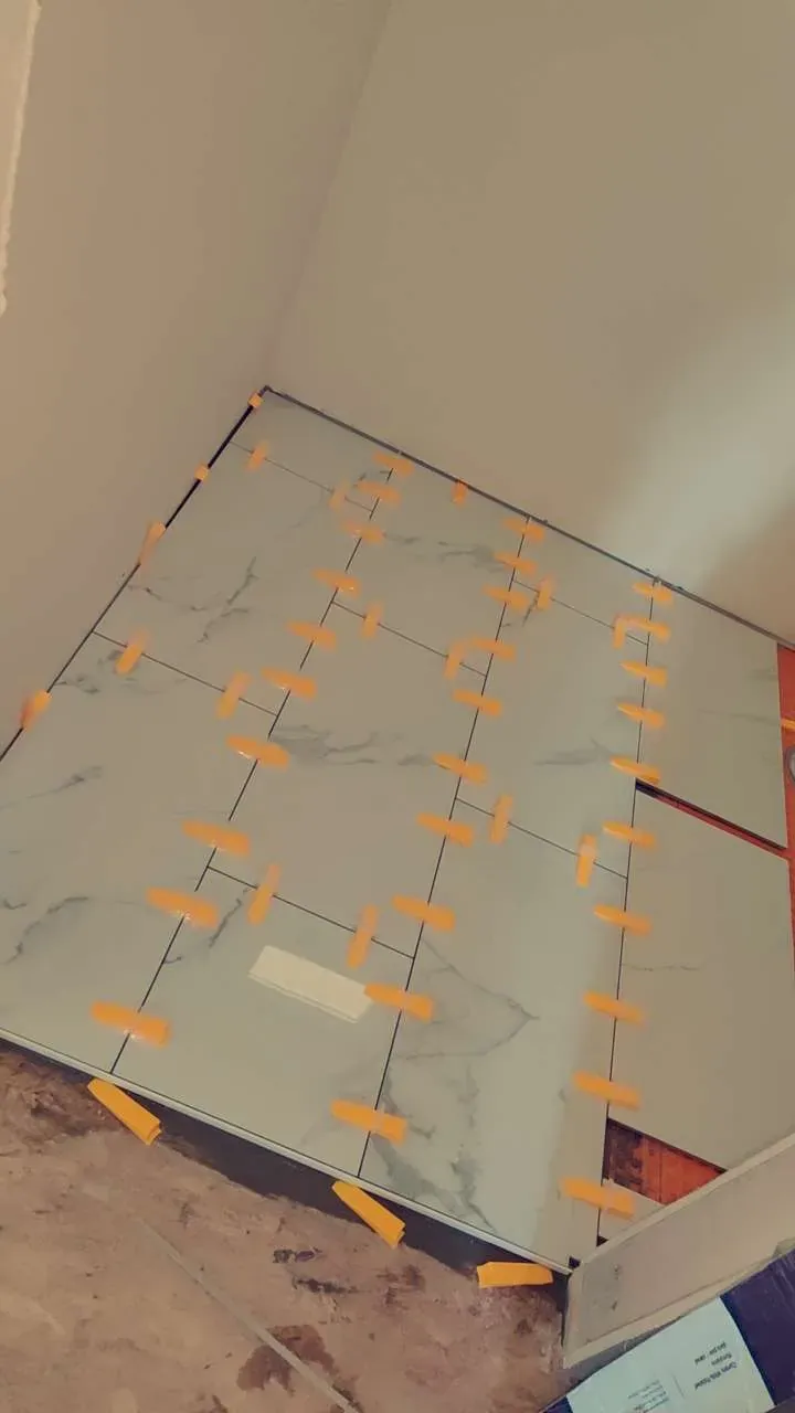 Large-format tile installation during an interior bathroom remodeling project