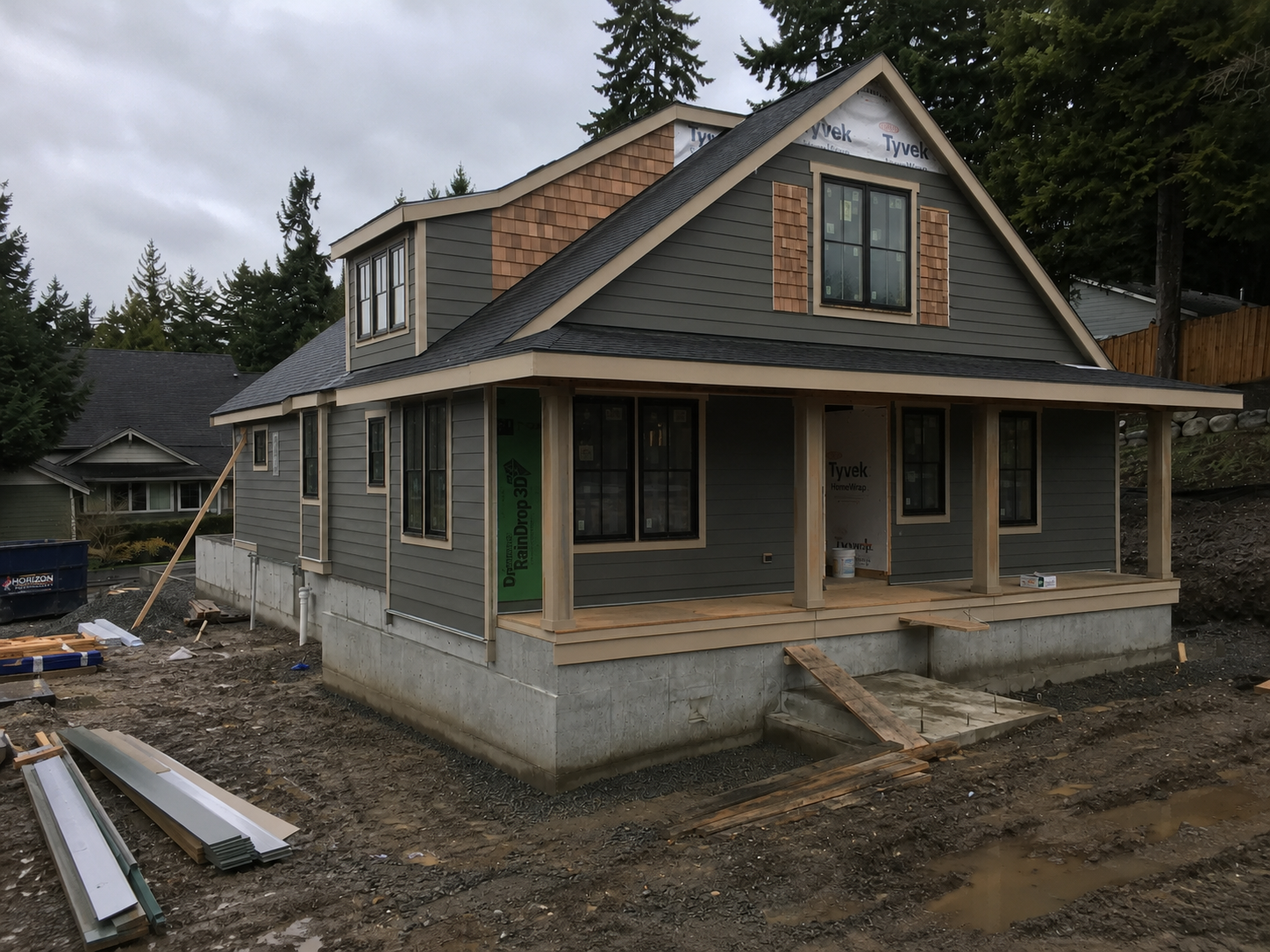 Completed home exterior with lap siding, cedar accents, trim, and window installation