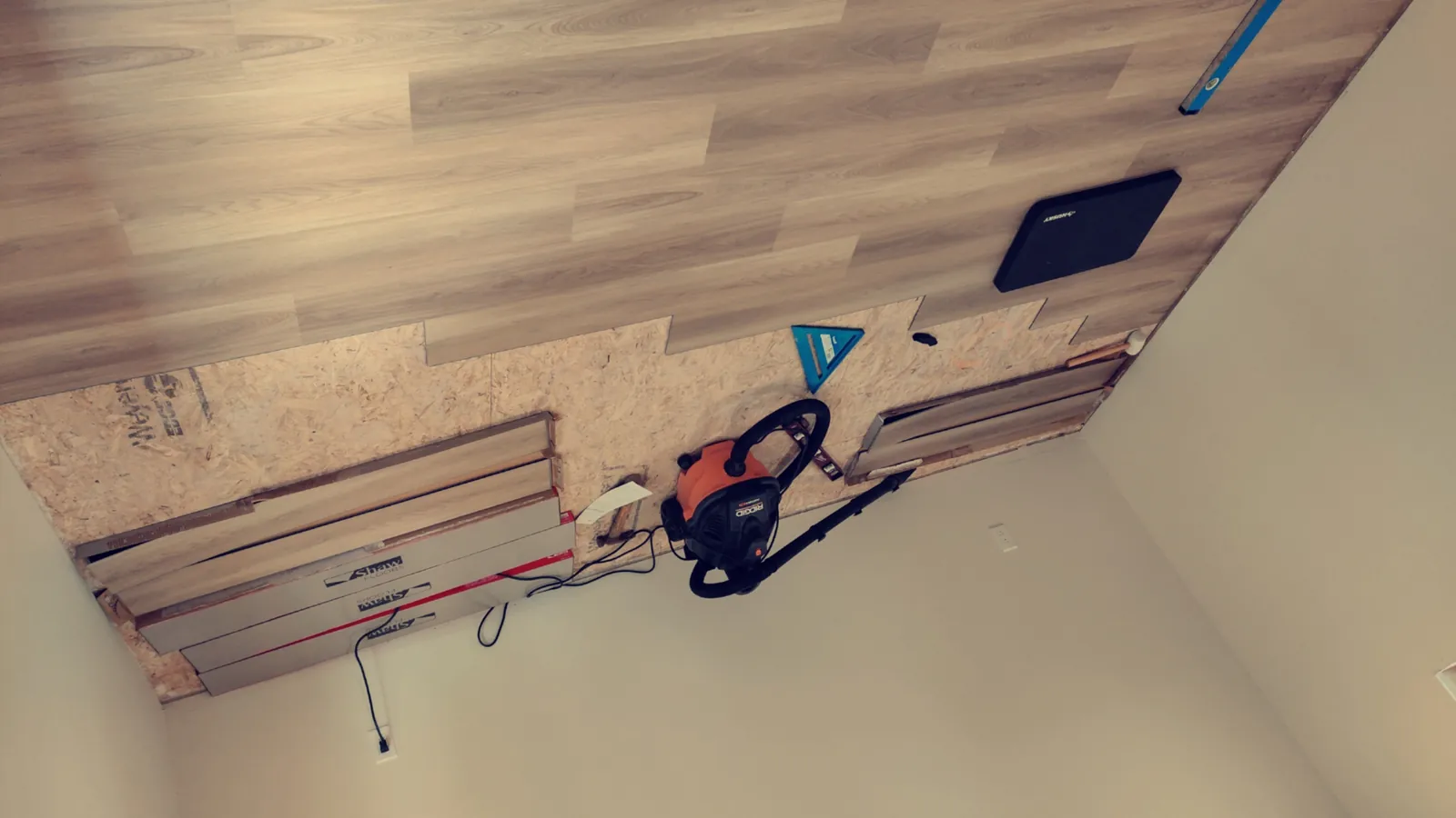 Marble-look tile aligned with leveling clips during a bathroom renovation