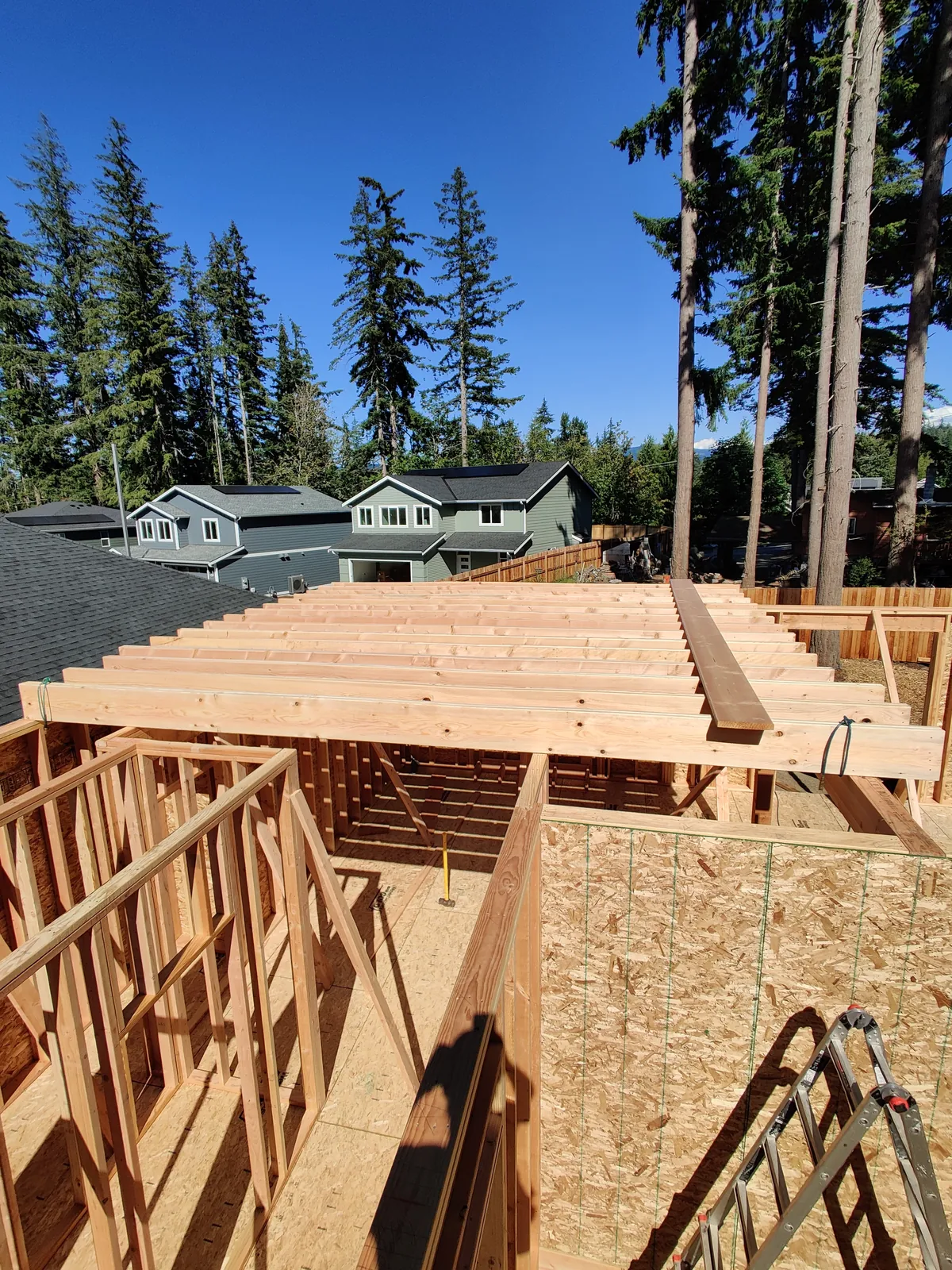 Residential wall, ceiling, and roof framing progressing on a Northwest home