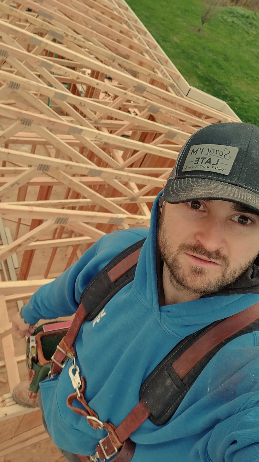 Carpenter working among roof trusses during residential construction